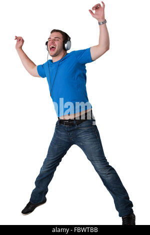 Young Man Listening to music and jumping Stock Photo