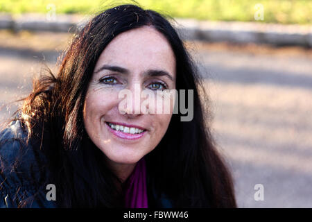 Mature Dark Haired Woman Smiling Stock Photo