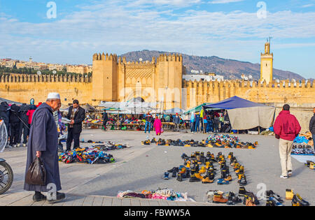 People with djellaba walking in market of Bab Chorfa at sunset, view from Bou Jeloud square. Fez El Bali Medina. Fez, Morocco. Stock Photo