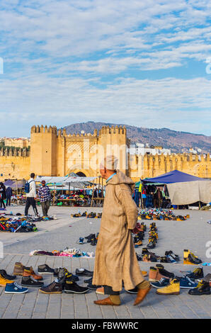 People with djellaba walking in market of Bab Chorfa at sunset, view from Bou Jeloud square. Fez El Bali Medina. Fez, Morocco. Stock Photo