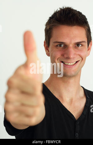 Happy smiling man doing two thumbs up Stock Photo