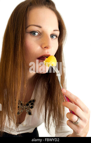 Cute young woman eating a potatoe Stock Photo