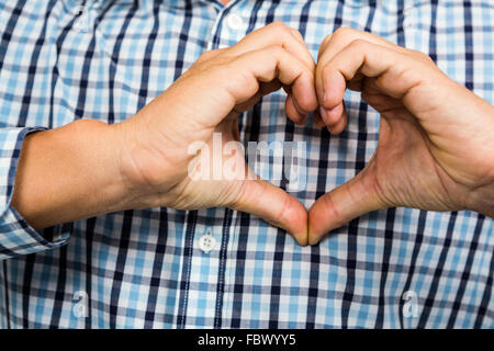 Cropped image of man making heart shape Stock Photo
