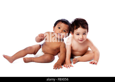 Two cute babies sitting together Stock Photo