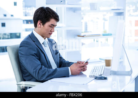 Asian businessman using his phone Stock Photo