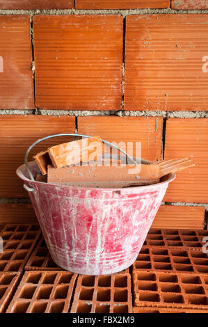 Masonry Bucket on hollow bricks Stock Photo