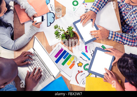 Business colleagues using technologies at desk Stock Photo