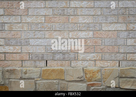 background of random brown tone brick wall over big rock, pattern Stock Photo