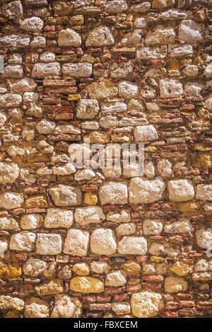Full of warm colors of the Italian wall background stones. Stock Photo