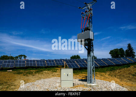 Electrical transformer on pole and solar panels small power plant Stock Photo