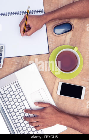 Overhead view of businessman working on laptop Stock Photo