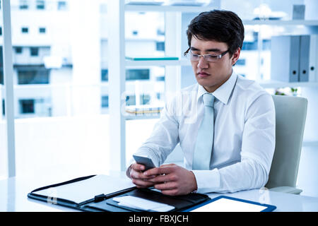 Focused asian businessman using his phone Stock Photo