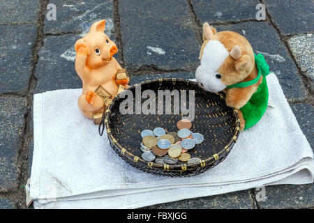 Busker's basket with coins, loose change Stock Photo