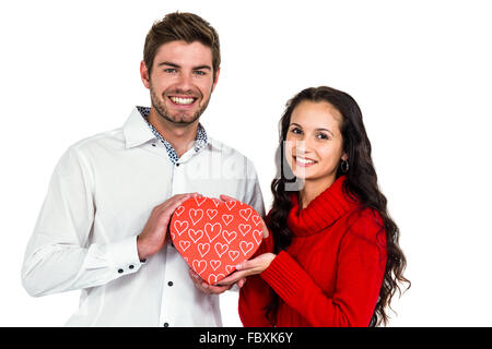 Couple holding heart shaped gift box Stock Photo
