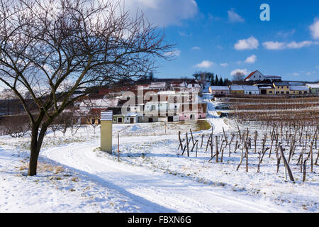 Snow covered wine cellars, vineyards and a Marterl on Mittelberg's Kellergasse in the Kamptal wine growing area of Lower Austria Stock Photo