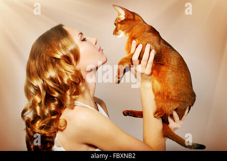 girl with Abyssinian cat Stock Photo