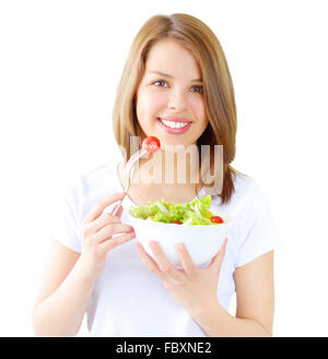 Teenager girl eating salad isolated on white Stock Photo