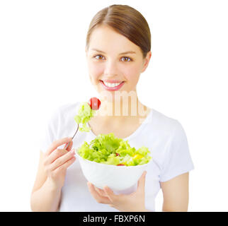 Teenager girl eating salad isolated on white Stock Photo