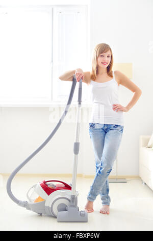 Attractive girl with vacuum cleaner Stock Photo