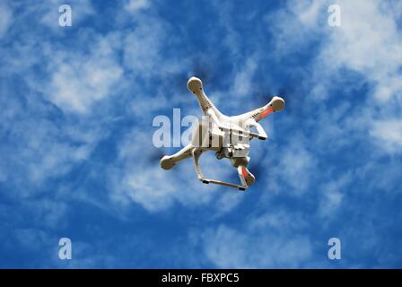 Flying Small Toy Drone on the Cloudy Sky. Drone Technology. Stock Photo