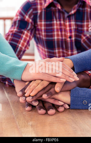 Business team stacking hands on desk Stock Photo