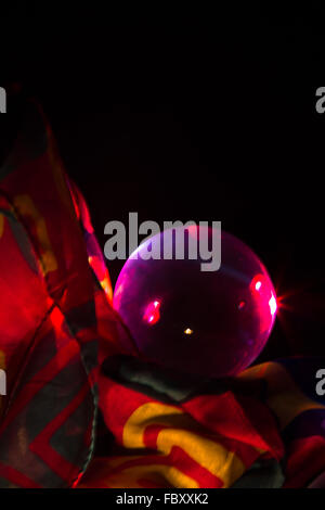 Crystal ball glowing with a purple hue Stock Photo