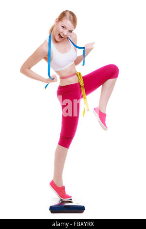 Weightloss, health and woman with measuring tape in a studio for her diet,  exercise or wellness. Fi Stock Photo by YuriArcursPeopleimages