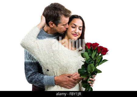 Man embracing and kissing girlfriend Stock Photo