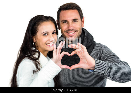 Smiling couple making heart shape with hands Stock Photo