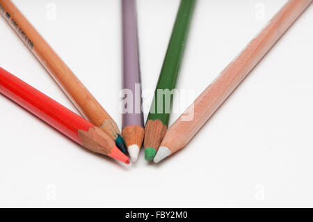 Five coloured pencils arranged on a white background Stock Photo