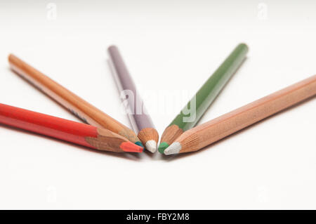 Five coloured pencils arranged on a white background Stock Photo