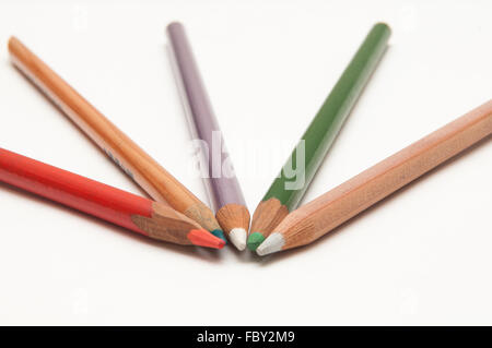 Five coloured pencils arranged on a white background Stock Photo