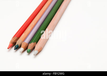 Five coloured pencils arranged on a white background Stock Photo