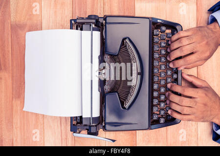 Businessman typing on typewriter Stock Photo
