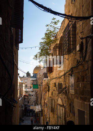 The Dome of the Rock seen at the end of a street from the Muslim Quarter of Old Jerusalem Stock Photo