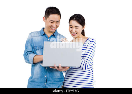 Cheerful couple using laptop Stock Photo