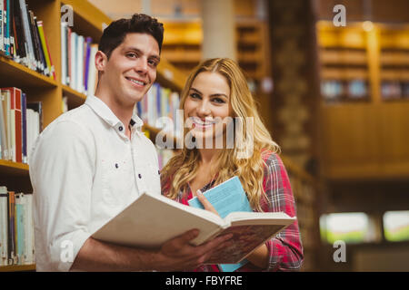College students reading book together Stock Photo