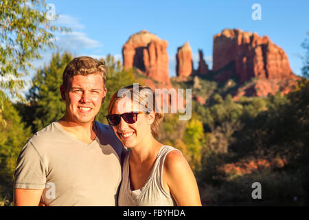 Couple at Red Rock Crossing in Sedona at sunset in autumn, with Cathedral Rock in distance Stock Photo