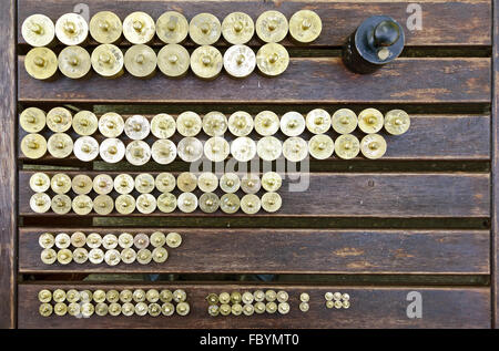 weights made from brass on a wooden table Stock Photo