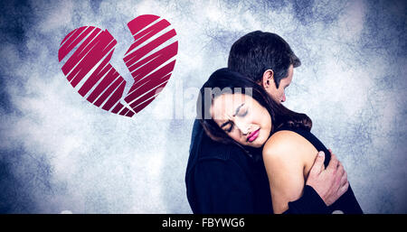 Composite image of sad couple embracing Stock Photo