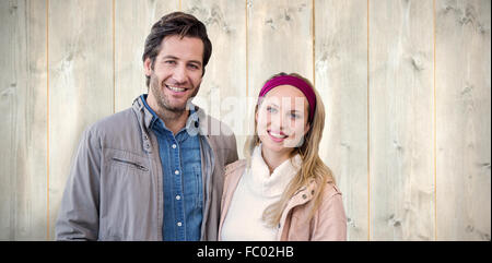 Composite image of smiling couple looking at camera Stock Photo