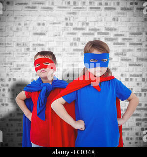 Composite image of masked kids pretending to be superheroes Stock Photo