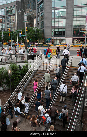 Commuters climbing the stairs up from the subway at Columbus Circle at 59th Street, New York, NY. Stock Photo