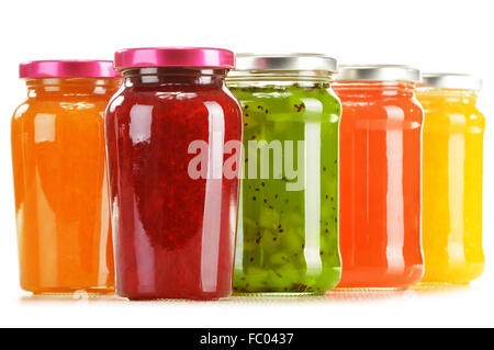 Jars of fruity jams isolated on white background. Preserved fruits Stock Photo