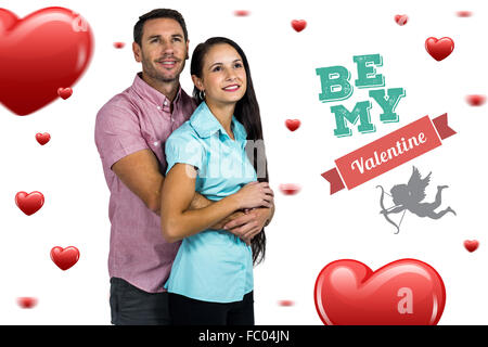 Composite image of thoughtful smiling couple hugging Stock Photo