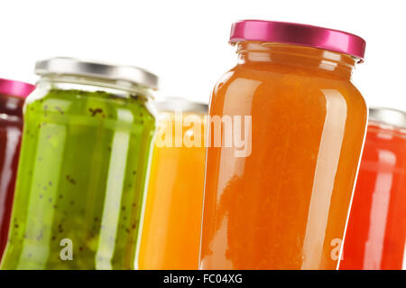 Jars of fruity jams isolated on white background. Preserved fruits Stock Photo