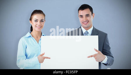 Business partners presenting sign together Stock Photo - Alamy