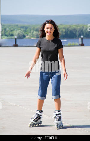 Young woman on roller skates Stock Photo