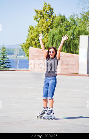 Woman on roller skates in sunglasses Stock Photo