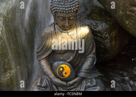 Buddha statue with the Yin & Yang Sign Stock Photo